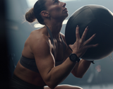 Woman holding a medicine ball considering hyrox race nutrition