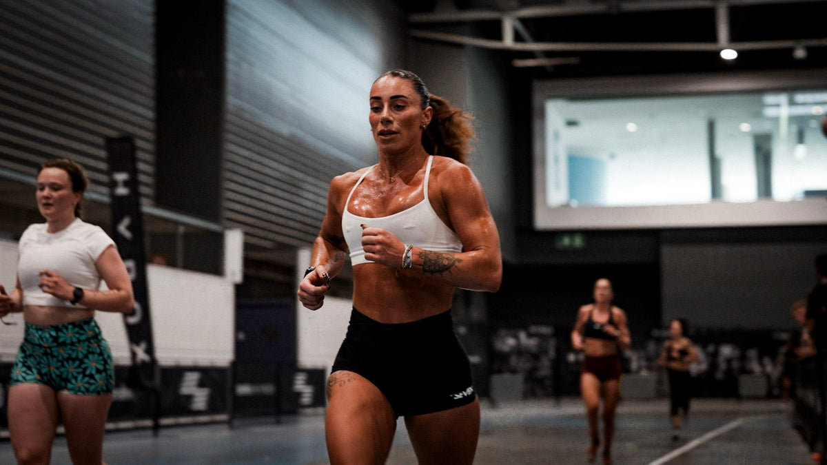 Woman holding a medicine ball considering hyrox race nutrition